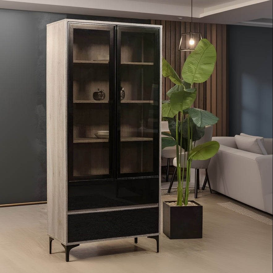 Tall black and beige cabinet with glass doors in a room setting.