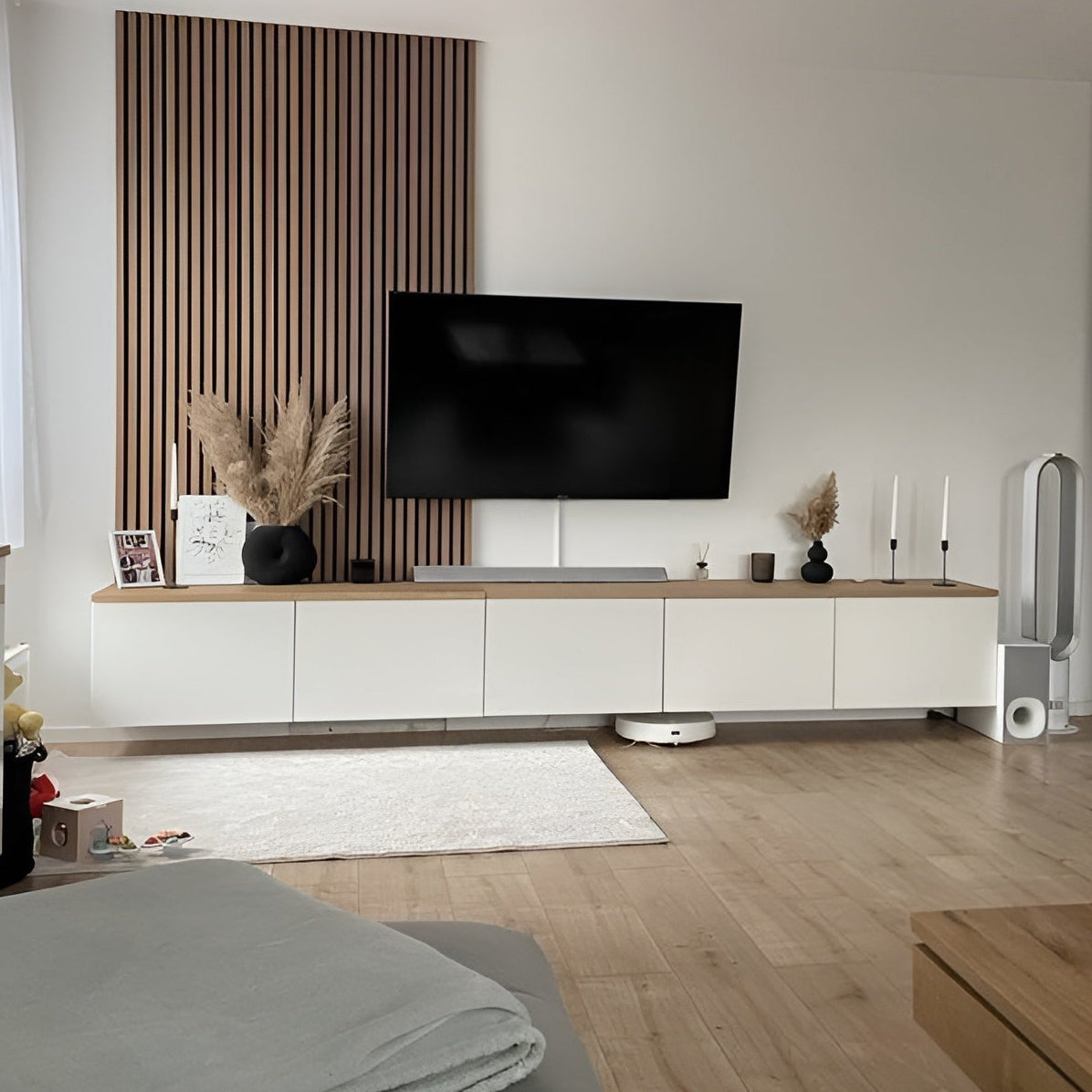 Modern living room with a television mounted on a wall panel