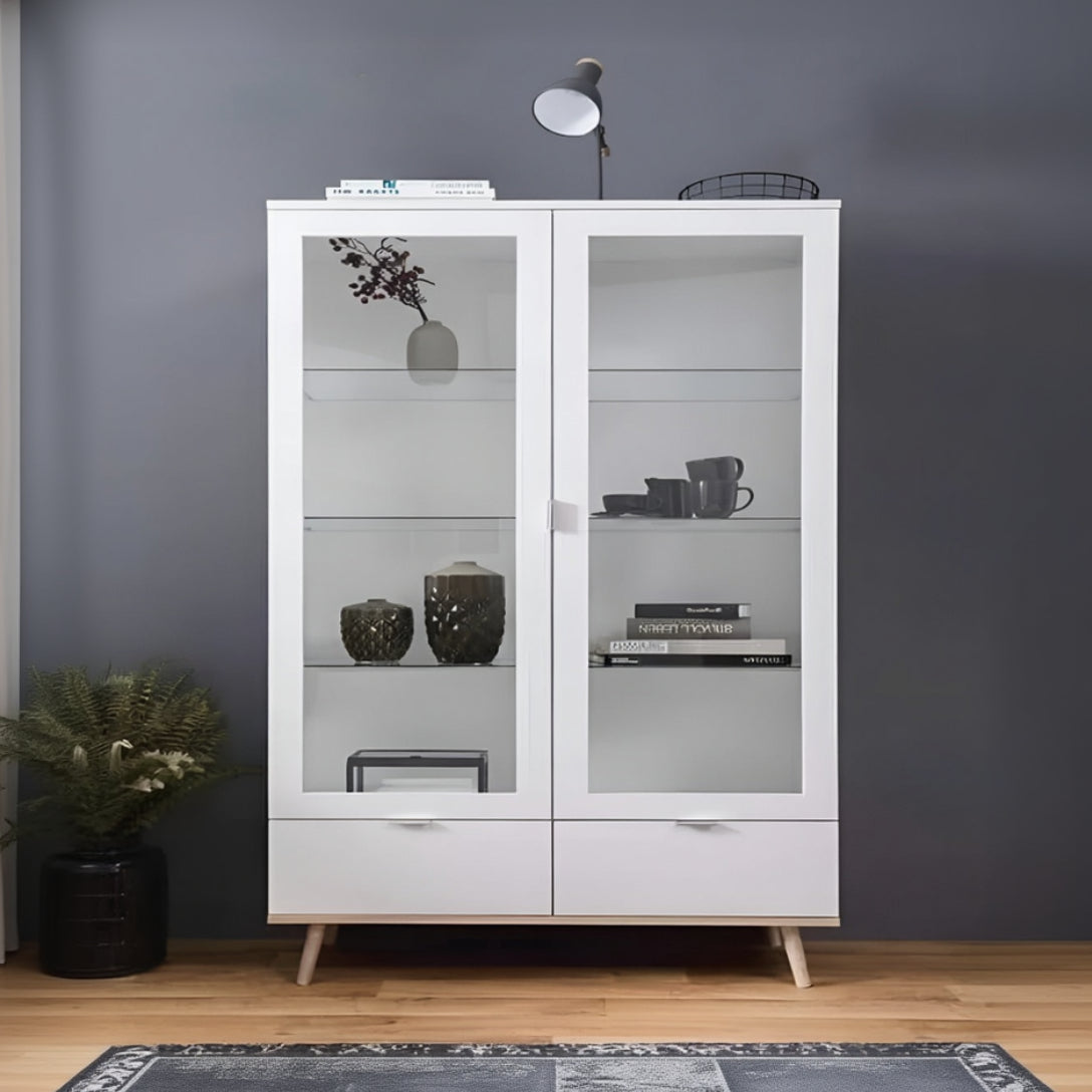 White display cabinet with glass doors against a gray wall