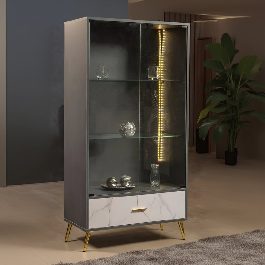 Modern display cabinet with glass shelves and marble base in a room setting.
