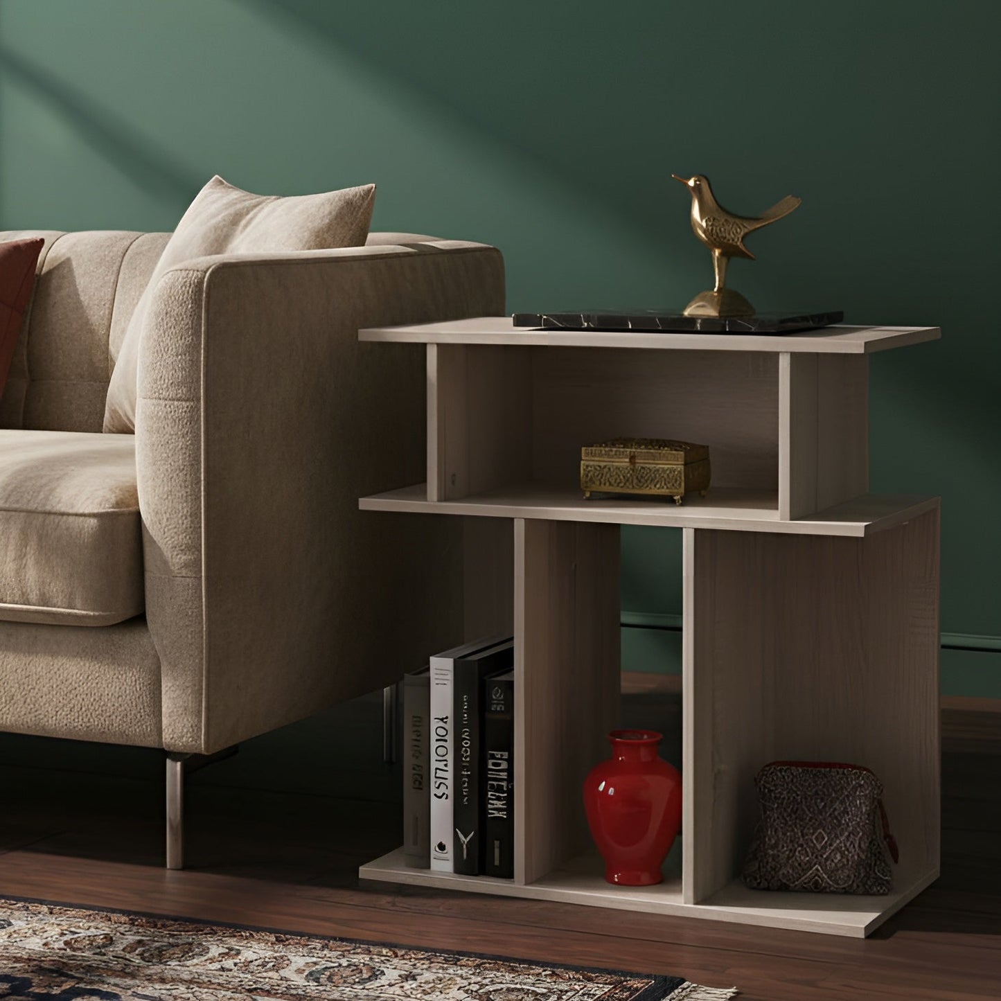 Modern living room with a beige armchair, coffee table, and decorative items against a green wall.