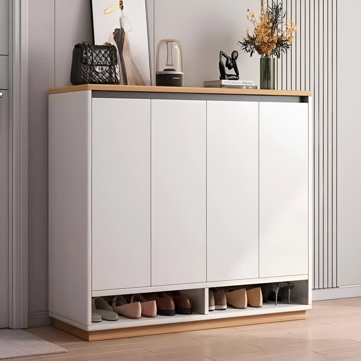 White shoe cabinet with wooden accents in a room setting.