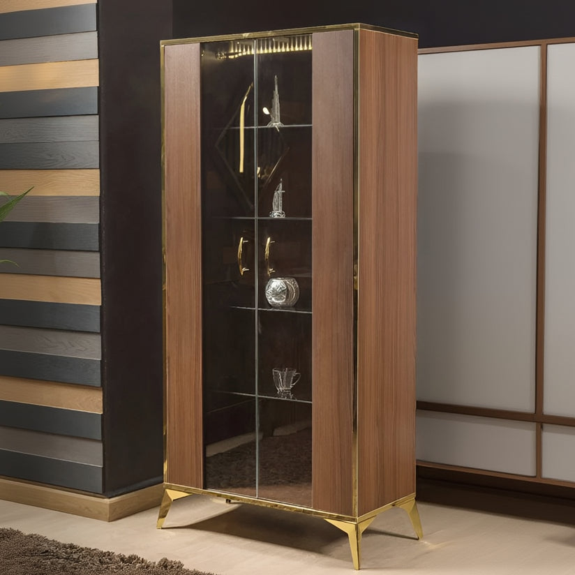 Wooden display cabinet with glass doors and gold accents against a neutral wall.