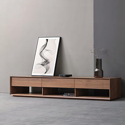 Wooden TV stand with a vase and abstract art against a gray wall.