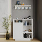 White cabinet with decorative items against a gray wall