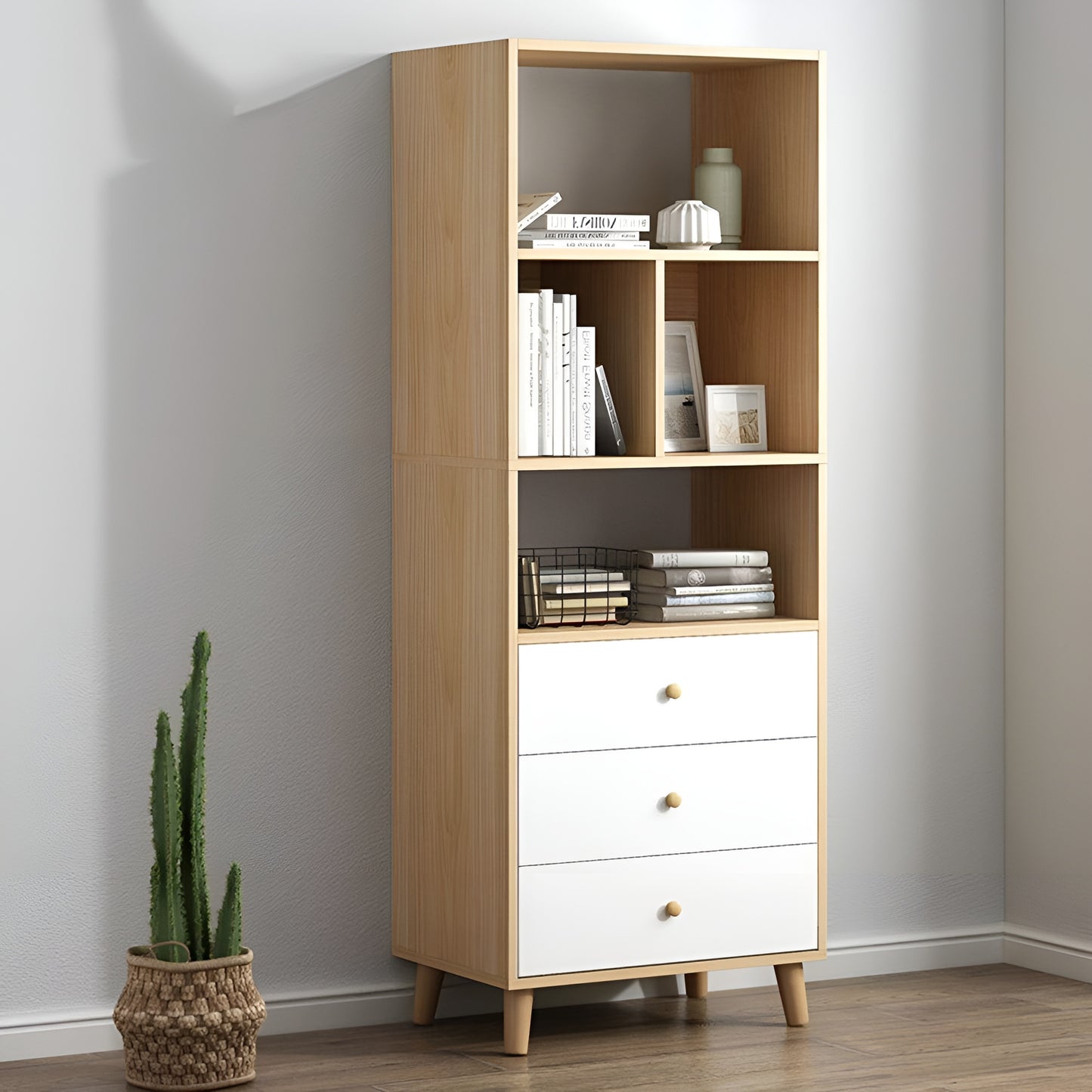 Wooden bookshelf with white drawers against a gray wall