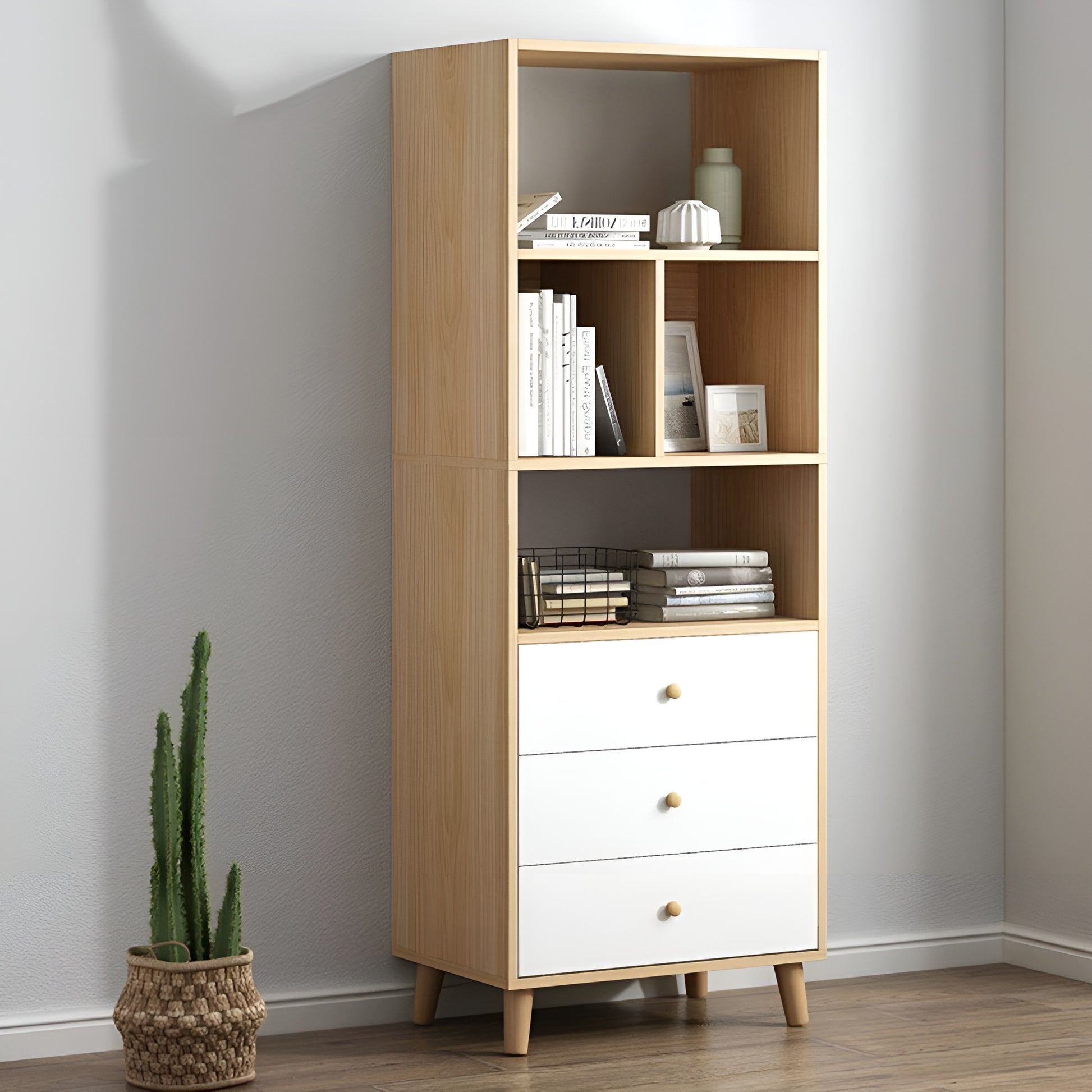 Wooden bookshelf with white drawers against a gray wall