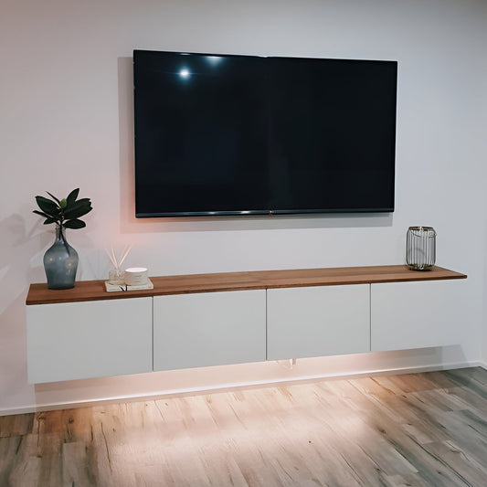 Modern living room with a large flat-screen TV mounted on the wall above a wooden shelf.