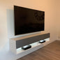 Modern TV stand with a television mounted on a wall in a room.
