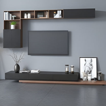 Modern living room setup with a TV and shelves against a gray wall.