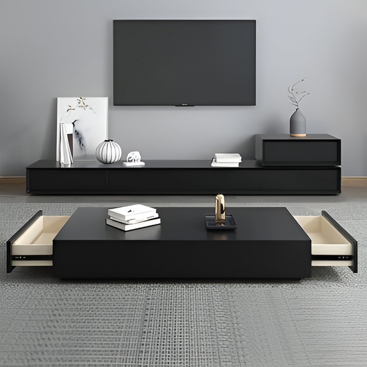 Modern living room with black TV stand and coffee table against a gray wall.