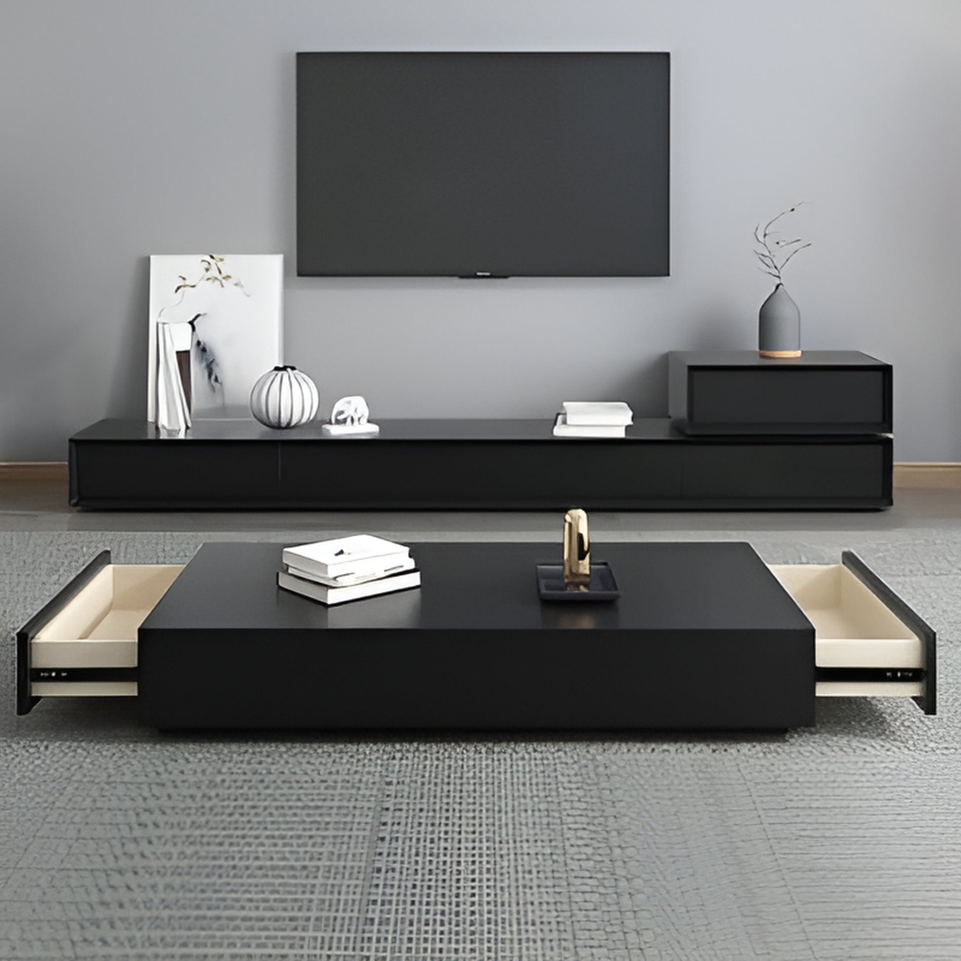 Modern living room with black TV stand and coffee table against a gray wall.