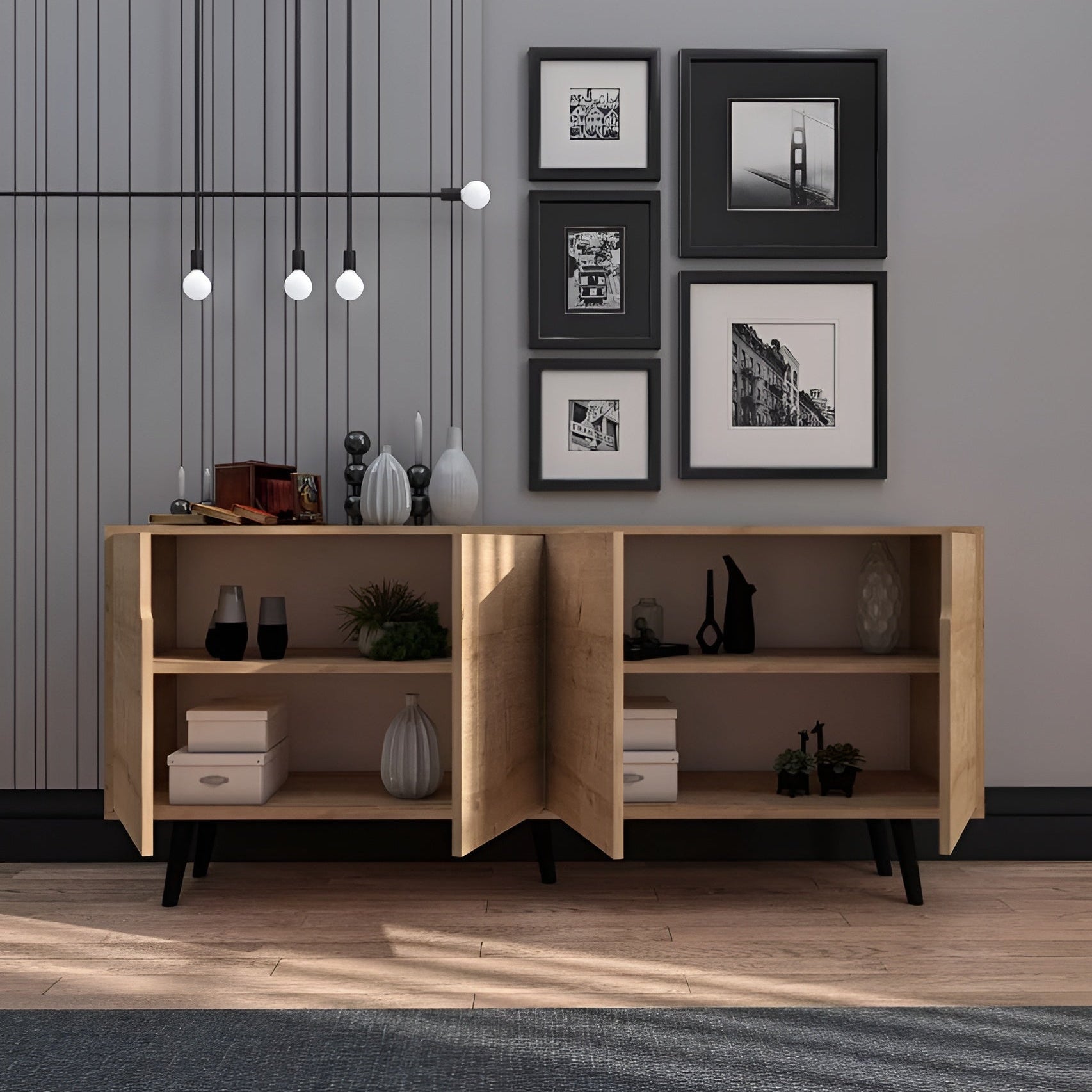 Wooden sideboard with open doors displaying decor items against a gray wall with framed pictures.