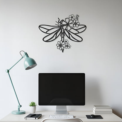Decorative metal wall art of a dragonfly on a white wall above a desk with a computer monitor.