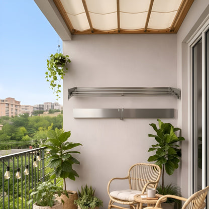 Balcony with wicker chairs, potted plants, and a rug on a sunny day.