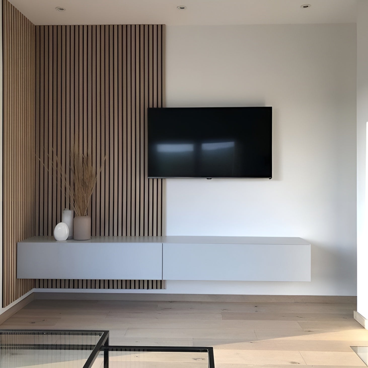 Modern living room with a television mounted on a wall with a decorative panel.