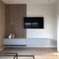 Modern living room with a television mounted on a wall with a decorative panel.