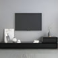 Modern living room with a black TV mounted on a gray wall, featuring a black entertainment console with decorative items.