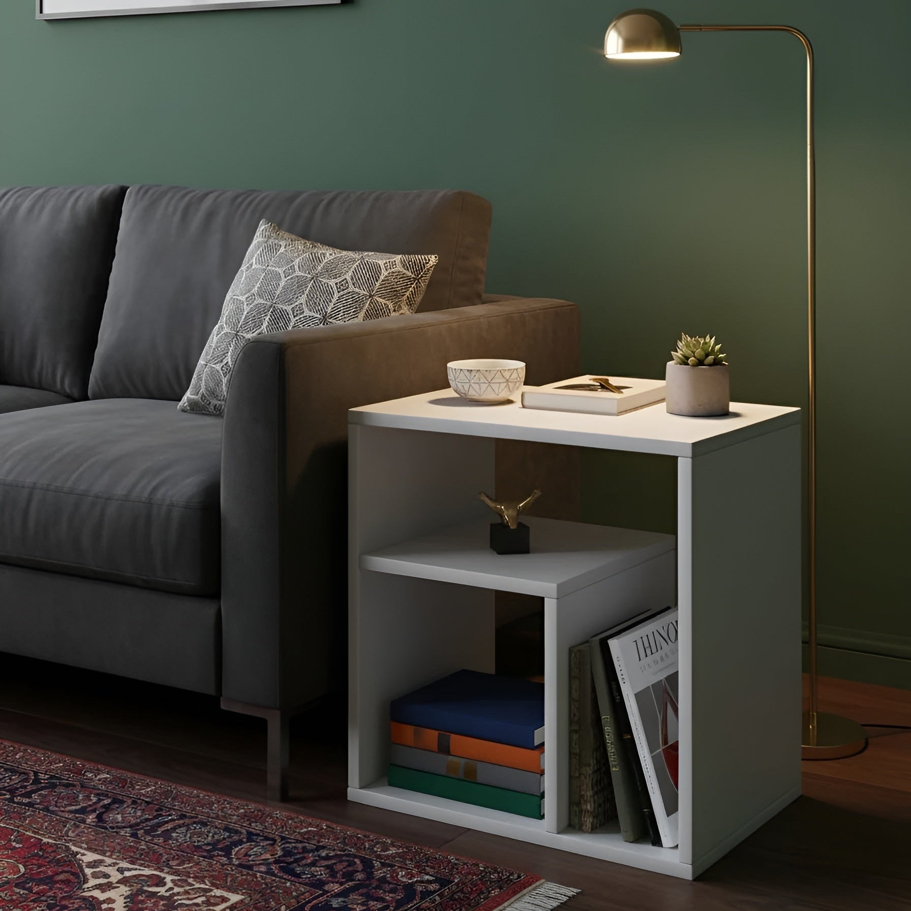 Living room with a gray sofa, white side table, and decorative items.