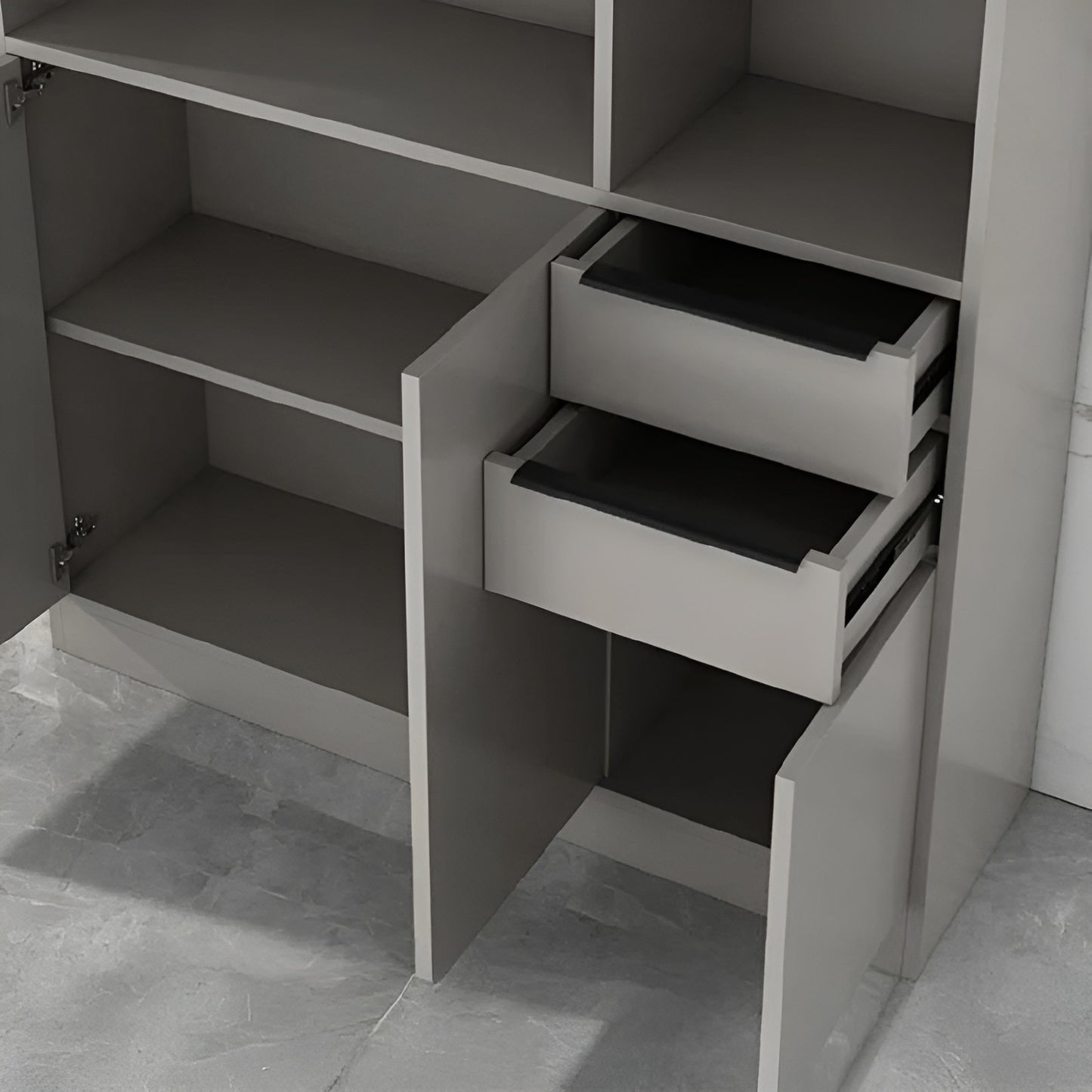 Gray cabinet with open drawers on a tiled floor
