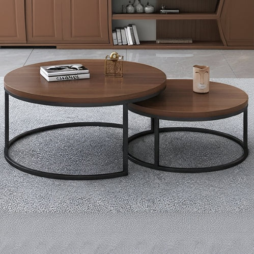 Two wooden coffee tables with black metal bases on a gray floor.