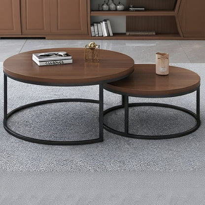 Two wooden coffee tables with black metal bases on a gray floor.