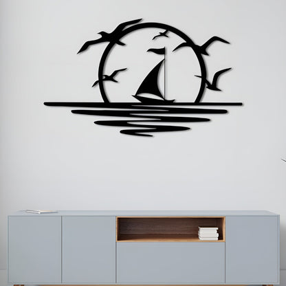 Decorative wall art of a sailboat and birds on a white wall above a light gray cabinet.