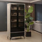 Tall black and beige cabinet with glass doors in a room setting.