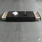 Black coffee table with open drawers on a gray textured floor