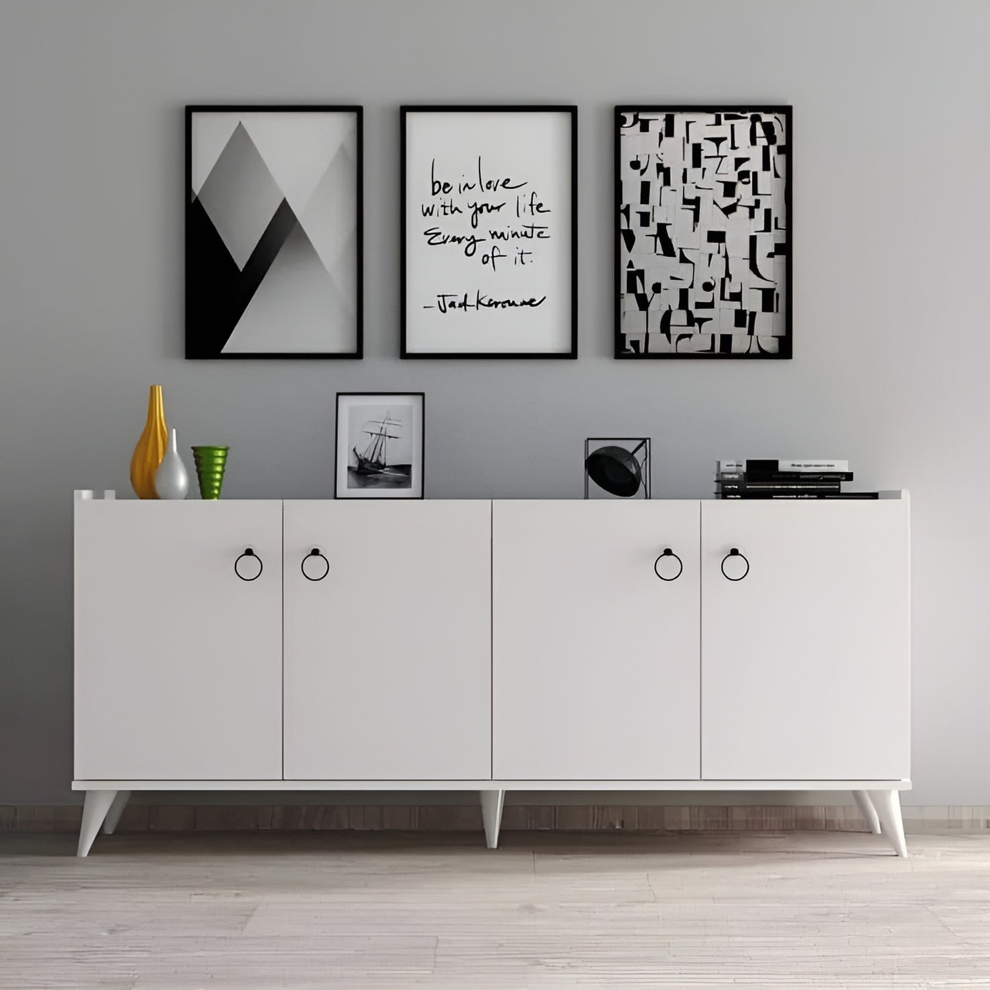 White sideboard with decorative items and framed art on a gray wall.