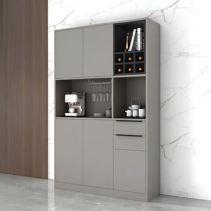 Gray kitchen cabinet with appliances and items against a marble wall.