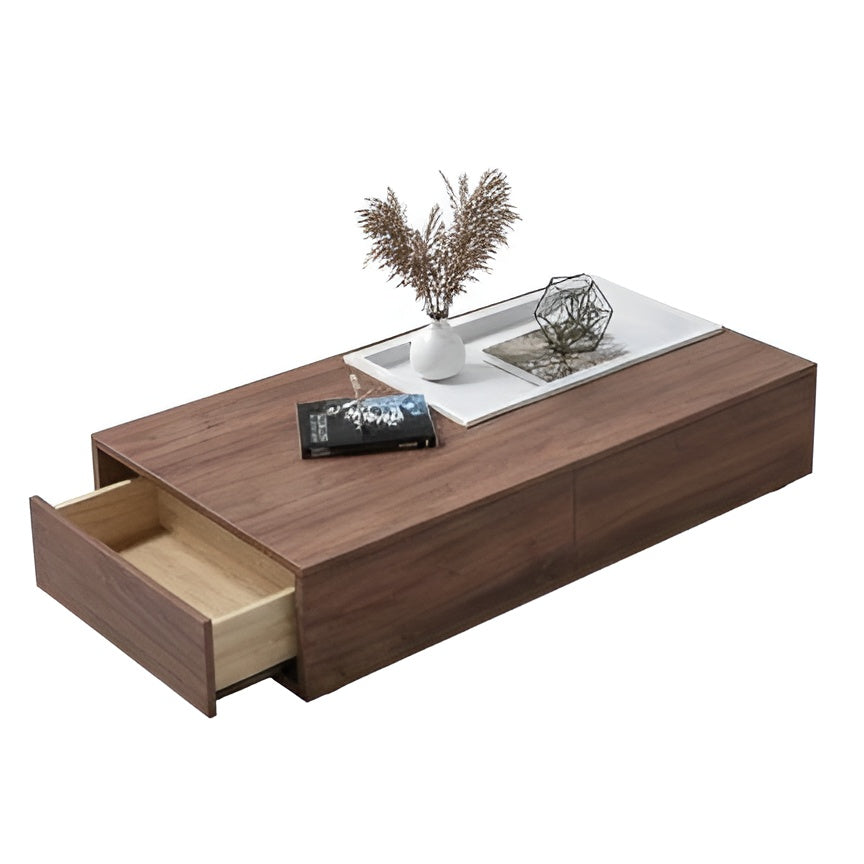 Wooden coffee table with a drawer, decorative items, and an open drawer on a white background