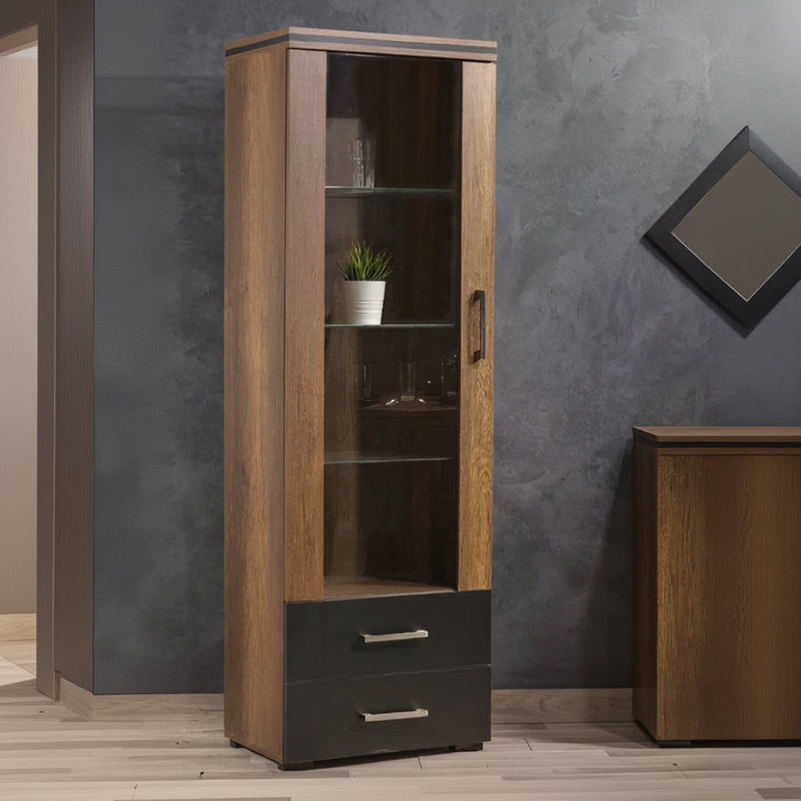 Tall wooden cabinet with glass doors and a drawer against a gray wall.