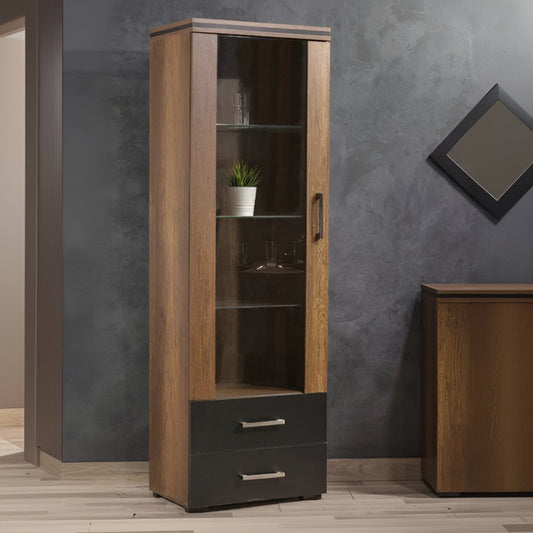 Tall wooden cabinet with glass doors and a drawer against a gray wall.