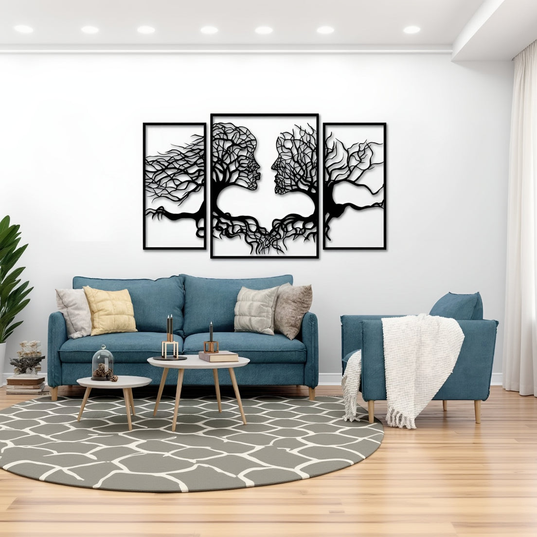 Living room with blue sofa, decorative pillows, and wall art of abstract trees.