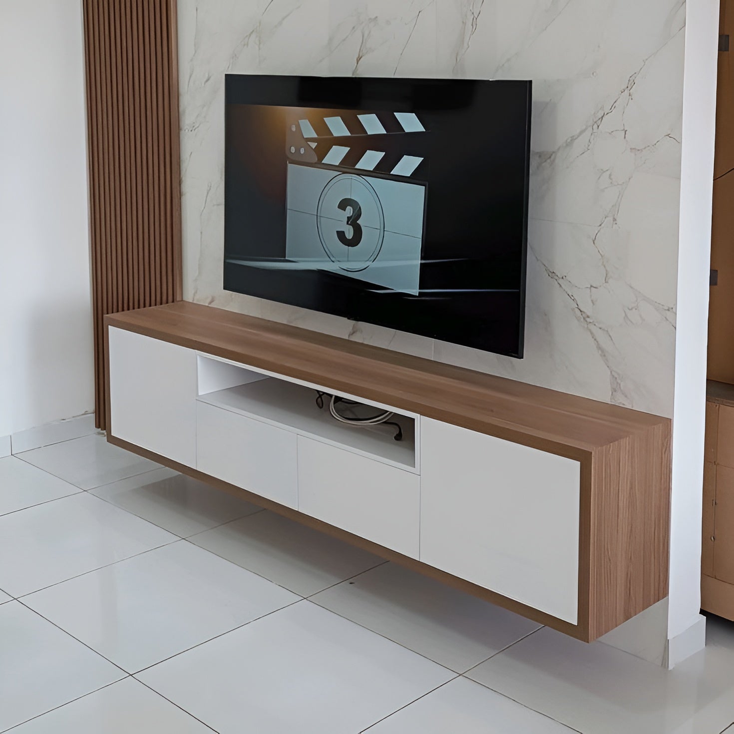 Modern TV stand with a wooden finish and white panels against a marble wall.