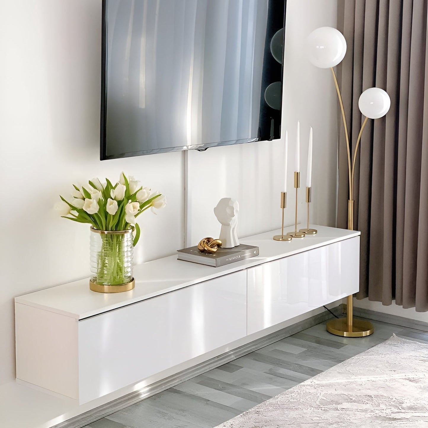 Modern living room with a white console table, TV, and decorative items.