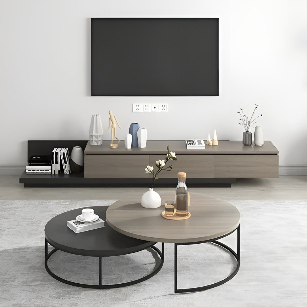 Modern living room with a television, coffee table, and decorative items.