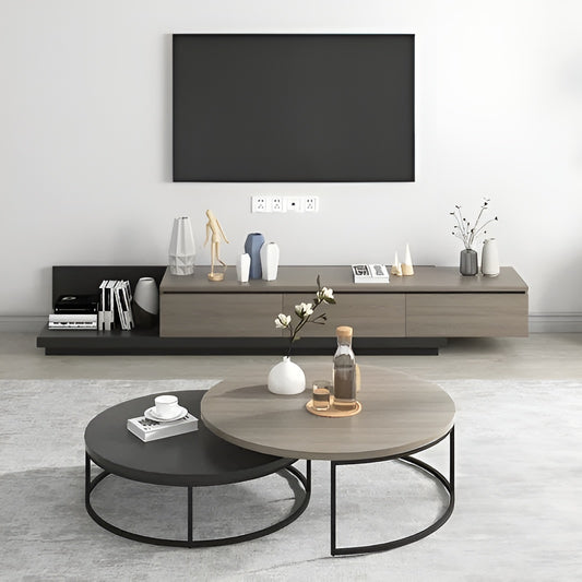 Modern living room with a television, coffee table, and decorative items.