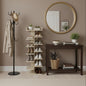 Shoe rack with shoes, coat stand, and round mirror in a room setting.