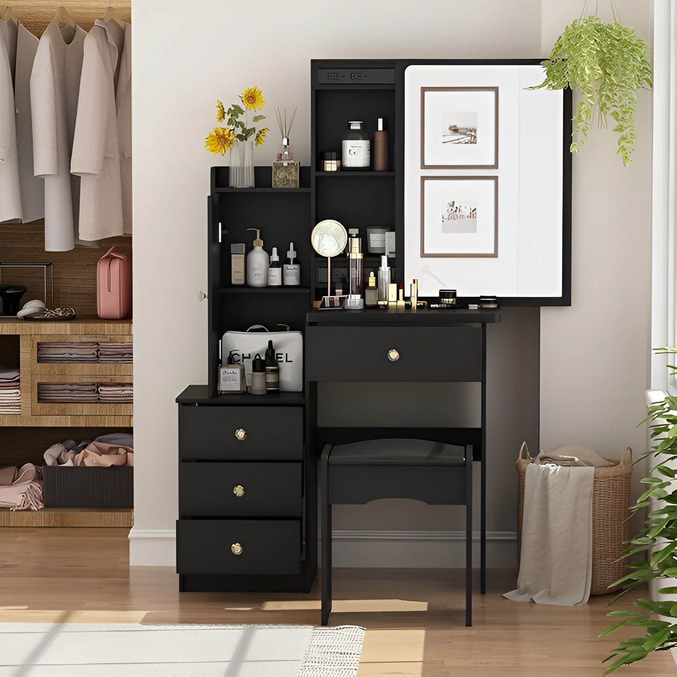 Black vanity desk with mirror in a room with clothing and plants