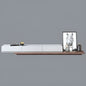 Modern wall-mounted shelf with decorative items against a gray background