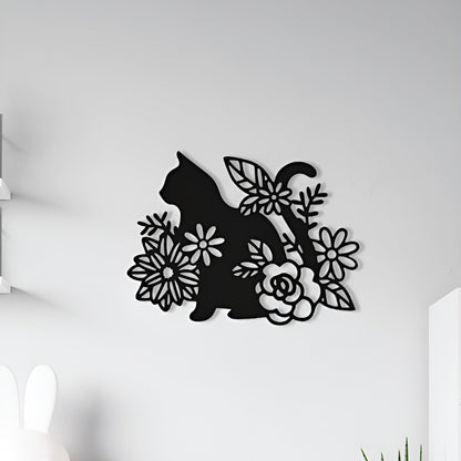 Decorative wall art of a cat silhouette with flowers on a white wall.
