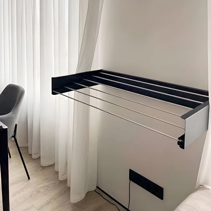 Foldable table with black frame and white surface in a room with light curtains.