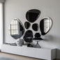 Modern wall mirrors with a geometric design on a light gray wall.