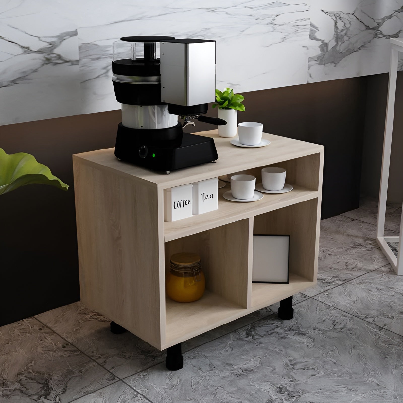 Coffee machine on a wooden side table with cups and a plant in a modern interior setting.