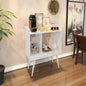 White side table with decorative items in a room setting