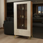 Decorative cabinet with glass doors displaying small objects in a dimly lit room.