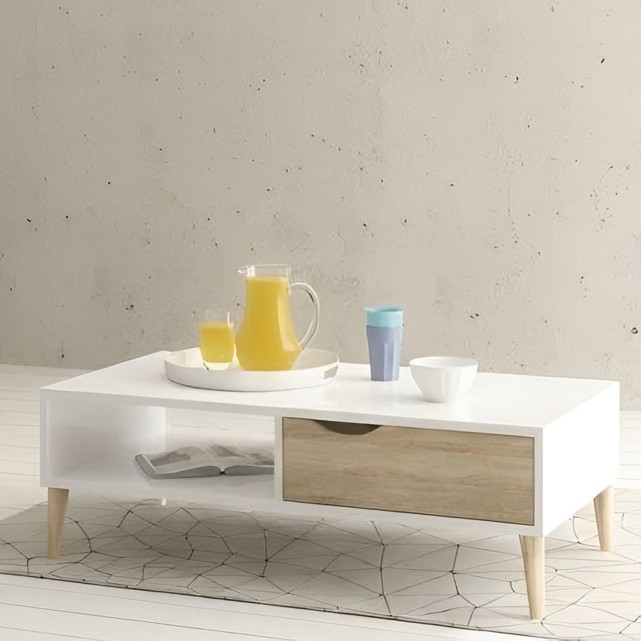 White coffee table with wooden legs holding a pitcher, glasses, and books against a light gray wall.