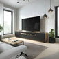 Modern living room with a television on a wooden stand, white walls, and decorative plants.